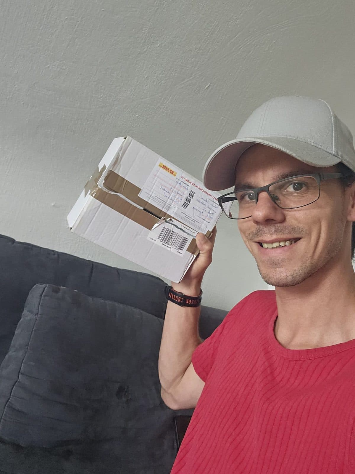 Teilnehmer hält das noch verschlossene Paket neben sein Ohr